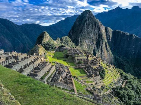 Explore the stunning ancient ruins of Machu Picchu, a UNESCO World Heritage Site in Peru, surrounded by majestic mountains.